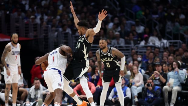 Milwaukee Bucks forward Giannis Antetokounmpo (34) defends Los Angeles Clippers guard James Harden (1)